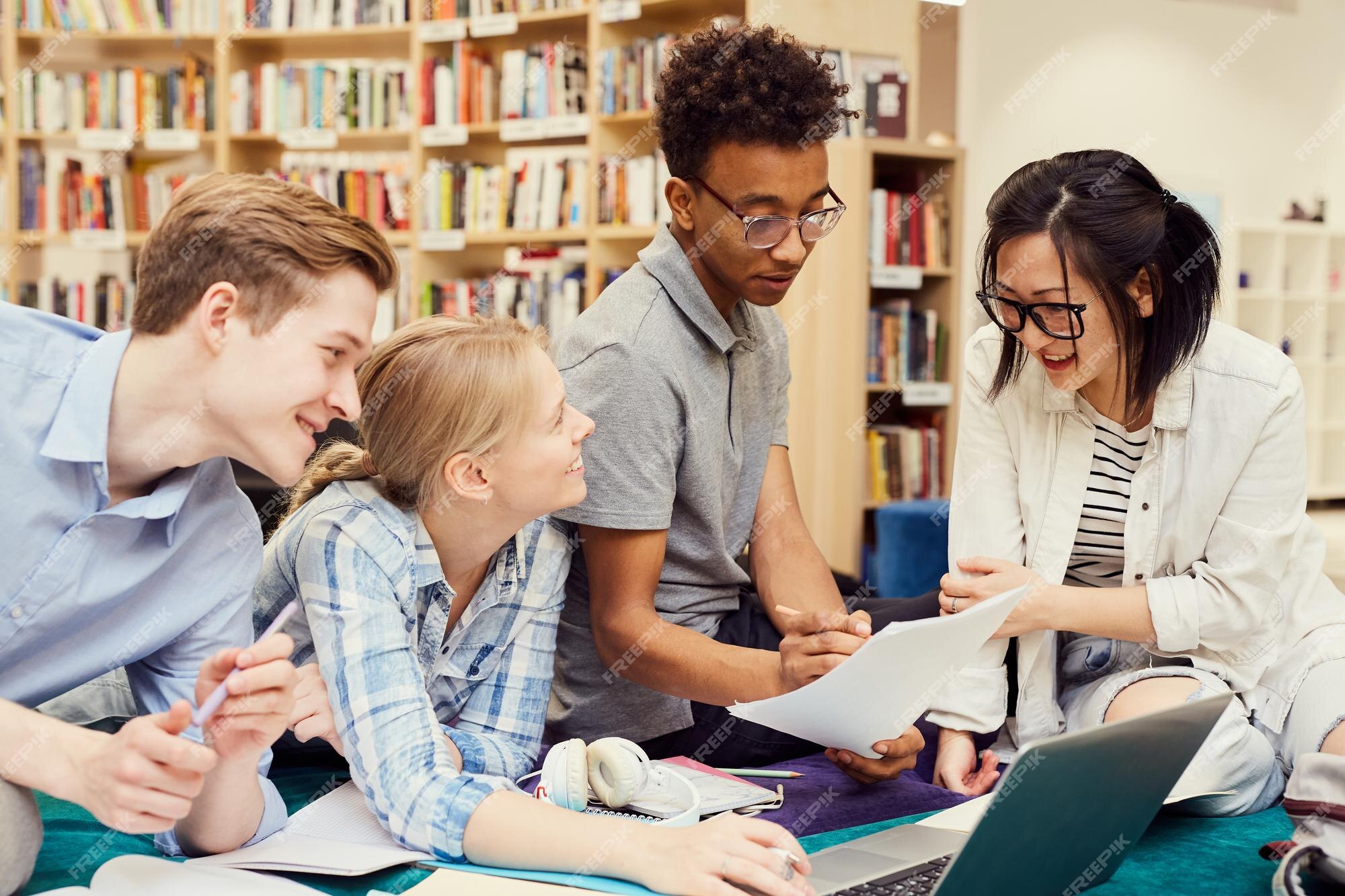 group-positive-young-multiethnic-students-studiying-modern-library_946859-3698